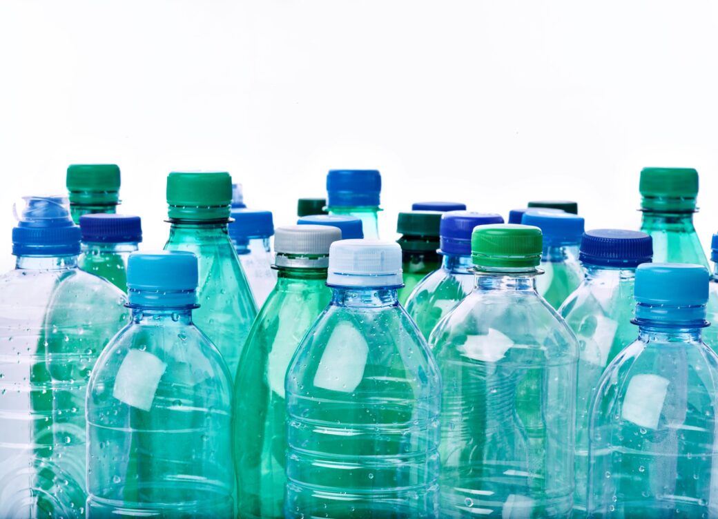 Multiple blue plastic bottles to represent the plastic packaging tax.