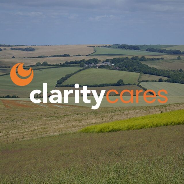 Clarity Cares logo on scenic landscape.